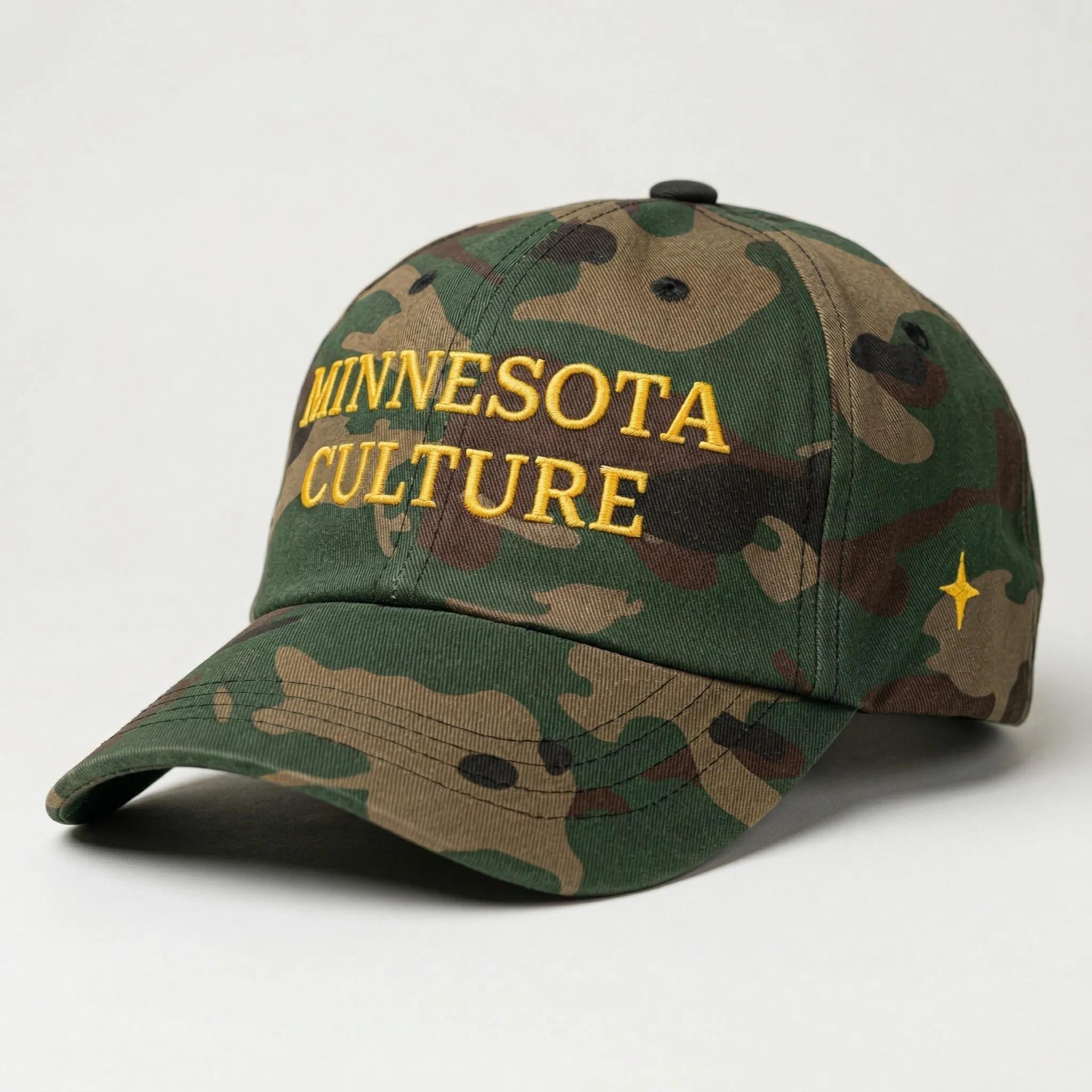 Camo colored dad hat, that that says "MINNESOTA CULTURE" in gold embroidery on the front panel, with gold embroidered 4 point north star on left panel