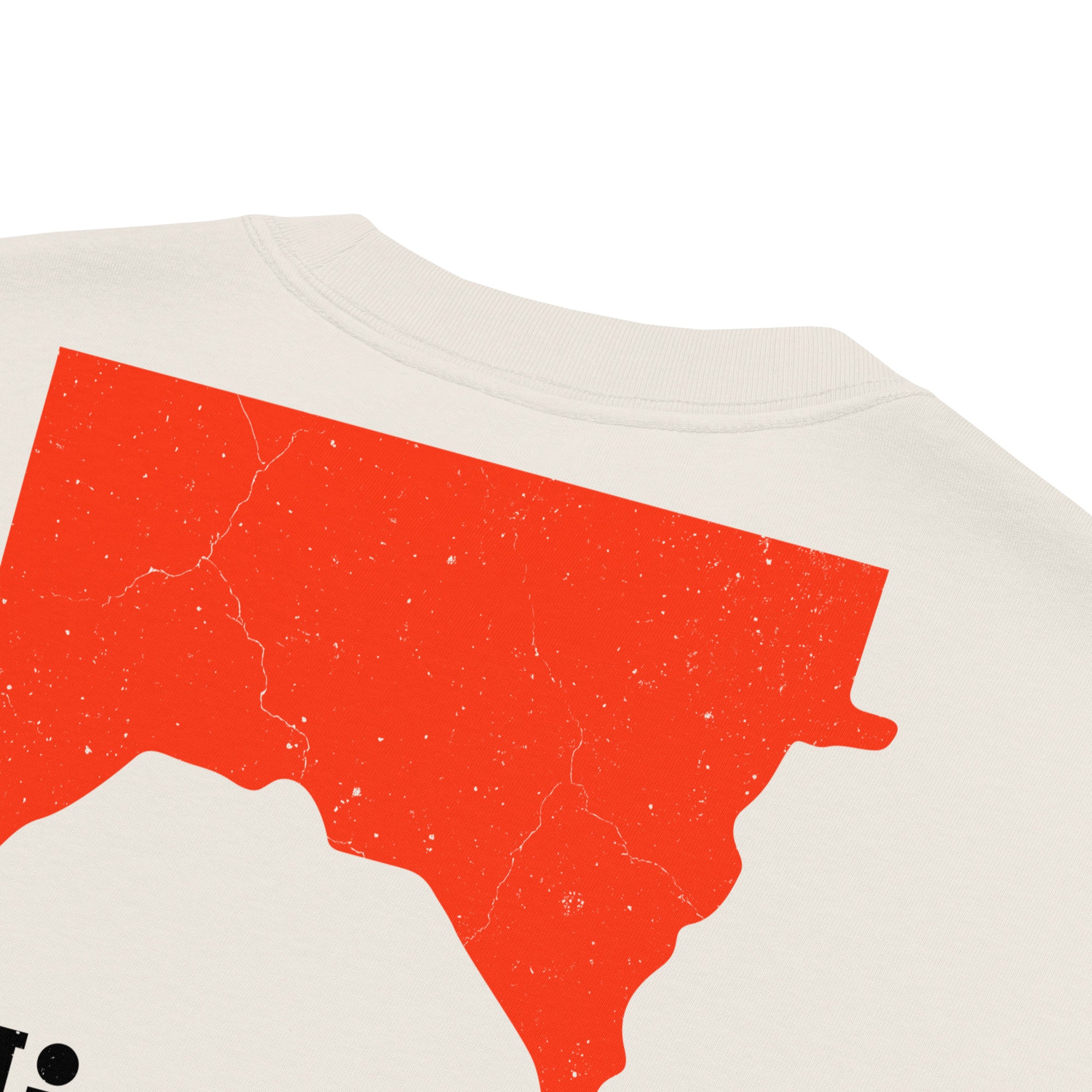 Detail closeup view of back of Beige colored Minnesota shirt with a flipped, red Minnesota shape with Minnesota text underneath, distressed marks, inspired by Marlboro logo